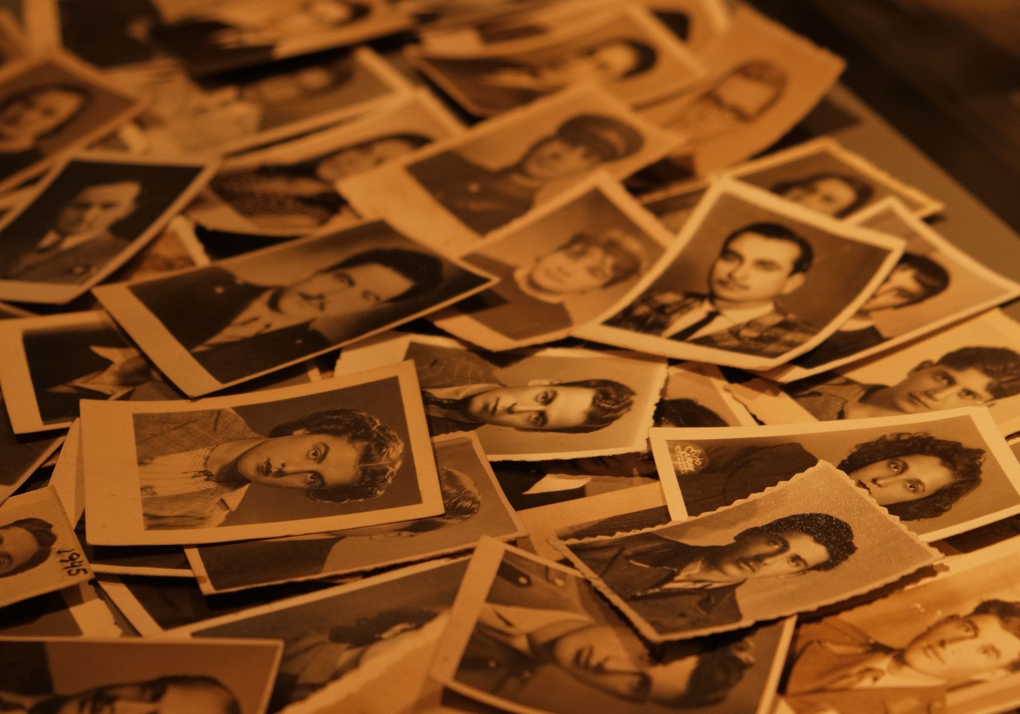 A pile of vintage sepia photographs